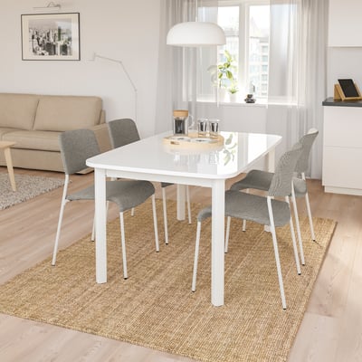 STRANDTORP 4-seat dining set with extendable table, white tabletop, steel legs, modern stackable chairs with cushioning.