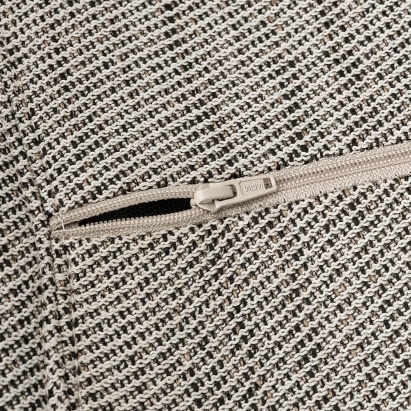 Close-up of STRANDTORP chairs durable zipper and textured, woven fabric, showcasing high-quality craftsmanship.