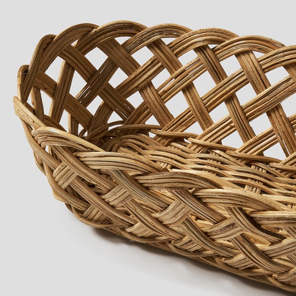 Woven rattan bread basket, handcrafted with intricate detail, showcasing natural texture and warmth.