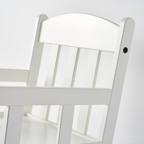 White wooden rocking chair, smooth finish, crafted with care. Curved back and sturdy base.