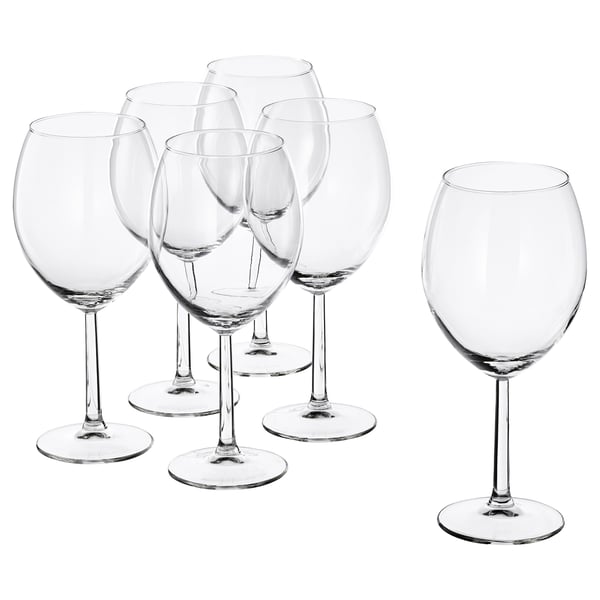 Six clear SVALKA glasses, modern designed with wide bowls, standing on flat surfaces, made of glass.