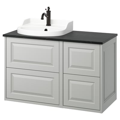 A TÄNNFORSEN light grey bathroom vanity with four drawers and a white ceramic sink. It sleek, beveled panels and a dark countertop.