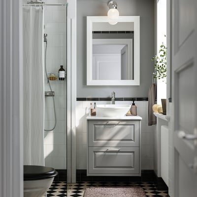 Gray bathroom with TÄNNFORSEN vanity & glass shower