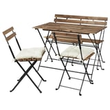 Foldable outdoor furniture set with table and chairs, brown wood and black metal, with white cushions.