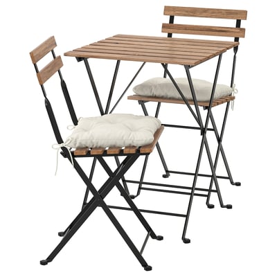 This set includes a wooden table and chairs with black metal frames, cushioned seats, designed for outdoor use.