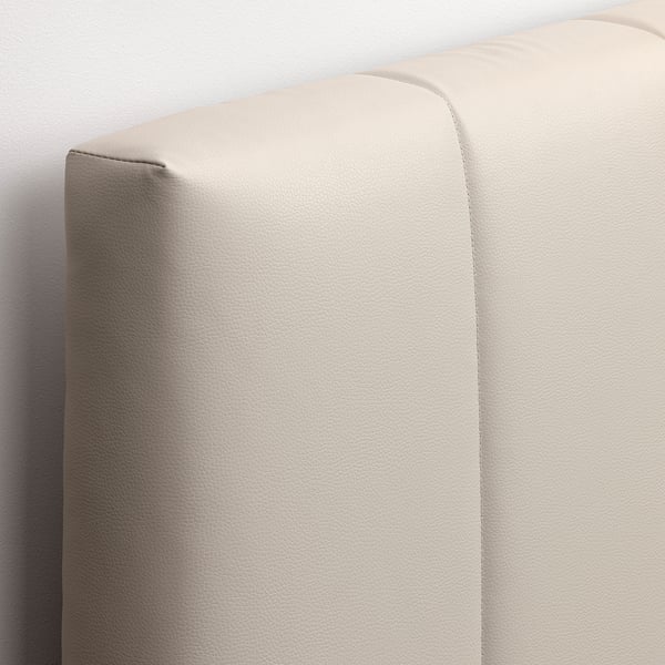 Close-up of padded, modern headboard with clean stitching, showcasing high-quality fabric and design.