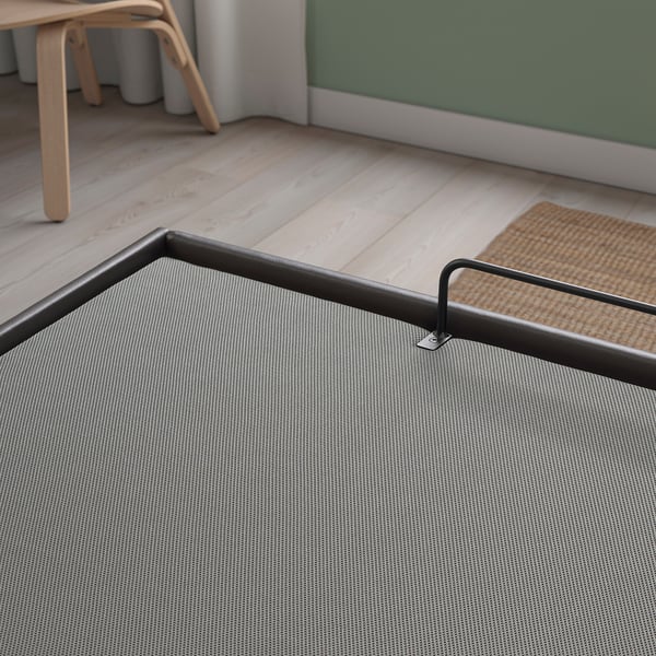 Modern TJÅLLE bed frame with durable, easy-care fabric, showcasing its storage space underneath.