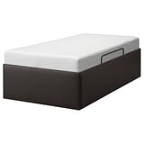Black TJÅLLE bed with white mattress, sleek design, built-in storage.