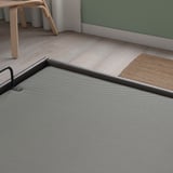 Modern TJÅLLE bed frame with durable, easy-care bomstad fabric, offering a spacious, clean storage solution.