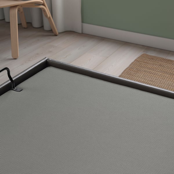 Modern TJÅLLE bed frame with durable, easy-care fabric and built-in gas springs for smooth lid movement.