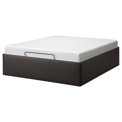 A TJÅLLE bed frame in black with a white mattress. It boasts a modern design with clean lines and offers hidden storage underneath.