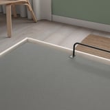 Modern bed frame with storage, gray fabric, sturdy handle, wooden floor setting.