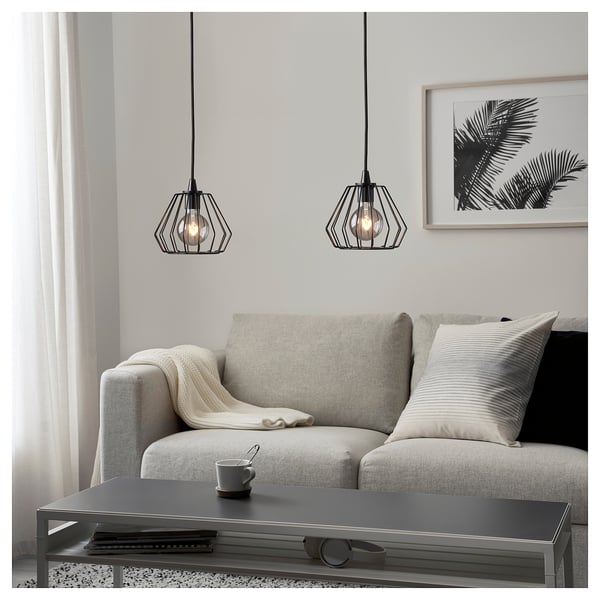 Modern living room with TJUGOTRE lamps, grey sofa, and tropical wall art.
