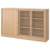 A light brown TONSTAD storage unit with sliding doors. It adjustable shelves and a classic, modern design.
