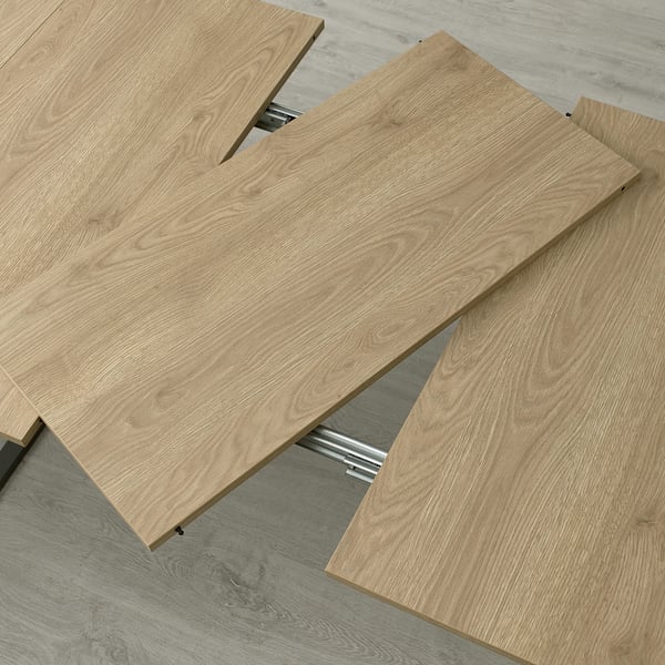 Wooden panels arranged for transforming table, showing expandable capability for seating.