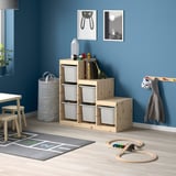TROFAST pine storage in kids room with toys, chairs, and rug.