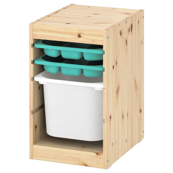 A wooden TROFAST storage unit with light pine finish, featuring a large white plastic bin below and three blue trays above.