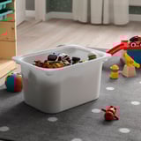 TROFAST bin with toys, lego, figures, cars on polka-dot rug.