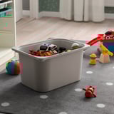 Large grey toy storage bin on a carpeted floor, holding assorted kids toys.