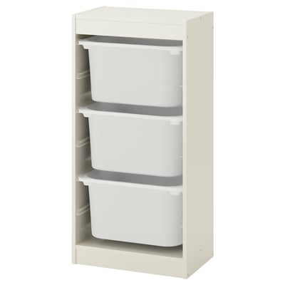 An off-white TROFAST storage unit with three white plastic bins. It has a modern, minimalist design with a wooden frame.