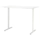 Adjustable white standing desk, TROTTEN model. Rectangular top, metal legs, crank handle for height adjustment.