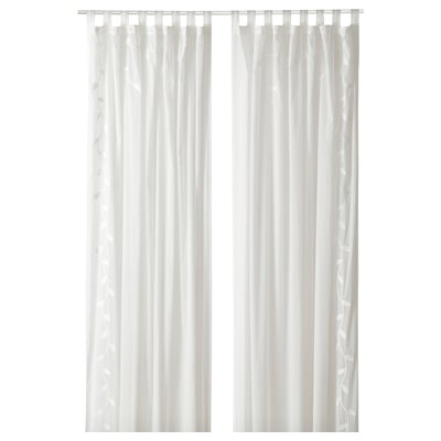Two white sheer curtains hang straight, with subtle leaf patterns, offering privacy while letting light through.