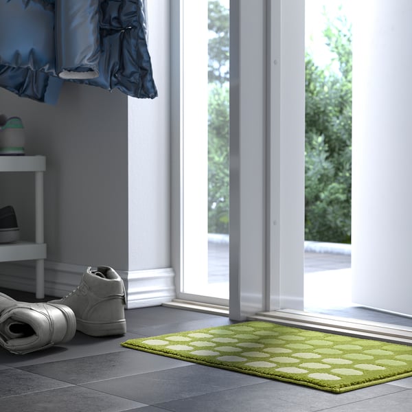 Green TUNNELBANA mat near doorway, freshens hallway.
