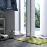 Green TUNNELBANA mat near doorway, freshens hallway.