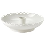 Round white ceramic candlestick with scalloped edge and central tube for candle.