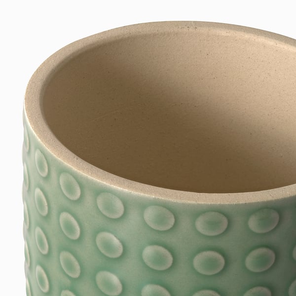 Close-up of a textured, mint-green TYSKLÖNN planter, showing its speckled stoneware quality.
