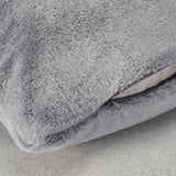 Close-up of soft, plush grey cushion with zipper, showcasing luxury feel and quality.