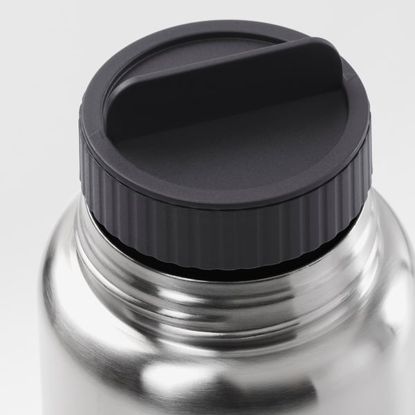 Close-up of durable, stainless steel travel mug lid, designed for no-spill pouring and secure closure.