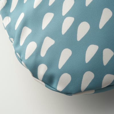 An aqua blue pet cushion with white teardrop patterns. Its square-shaped with a patterned fabric cover.