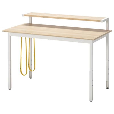 The UTVISNING gaming desk a light wooden top, metal legs, adjustable height, and yellow straps for cable management.