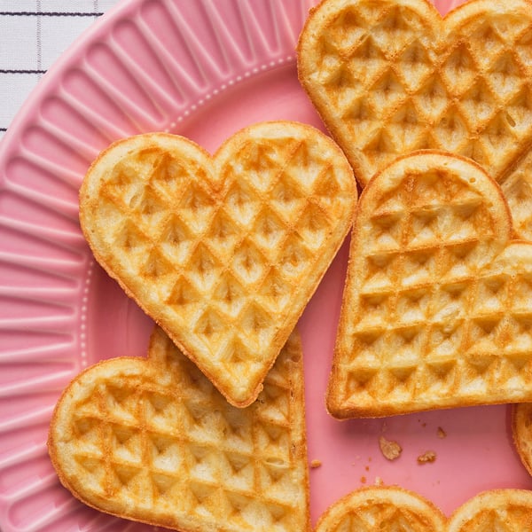 Heart-shaped waffles, crispy outside, soft inside. Served with jam, cream, or salmon. Perfect for dessert or appetizers.