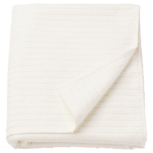 Folded white VÅGSJÖN towel, soft cotton, striped terry design.