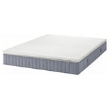 An ikea VALEVÅG rolled mattress in white and gray, designed for firmer support with pocket springs and a removable cover.