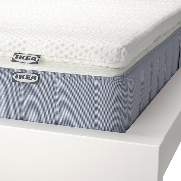 IKEA mattress set; white topper, blue fitted sheet; corner view, quality design.
