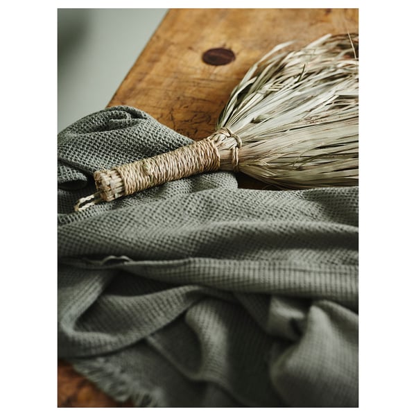 Gray cotton towel resting on wooden surface.