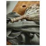 Gray cotton towel resting on wooden surface.