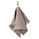 A light grayish-brown VALLASÅN towel hanging, made of cotton and viscose, featuring a waffle texture and fringe edges.