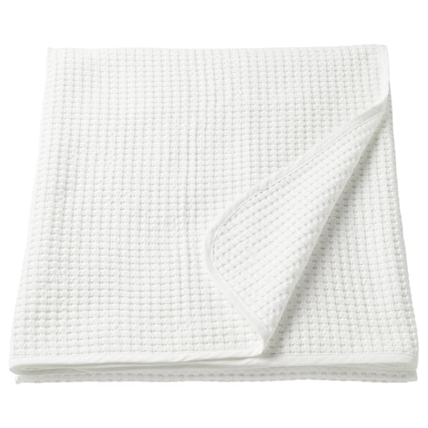 A white VÅRELD cotton bedspread, folded neatly, with a textured weave pattern.
