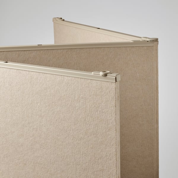 Beige room divider panel with metal edge detailing, folded neatly against a plain wall, showcasing sturdy, high-quality construction.