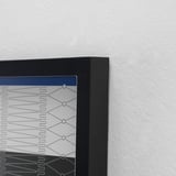 Black-framed photo display mounted on a white wall, showcasing a well-crafted design, emphasizing sleek, modern aesthetics.