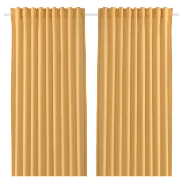 Two beige curtains hang side by side. They are solid, rectangular, and feature a rod pocket design, typically used for privacy and light control.