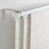 VIDGA curtain rail on ceiling with vertical blinds.