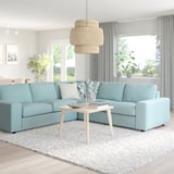 A modern light blue VIMLE sectional sofa in a bright living room, with a pendant lamp above and a coffee table in front.