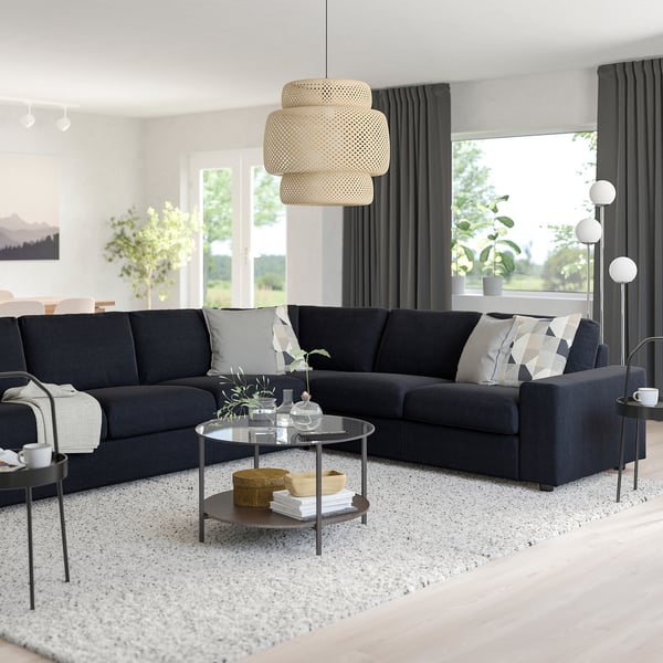 Dark gray VIMLE l-shaped sofa with storage coffee table, pendant lamp, and large windows.