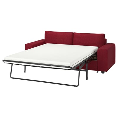 Red sofa-bed with white mattress, minimalist design, metal frame.