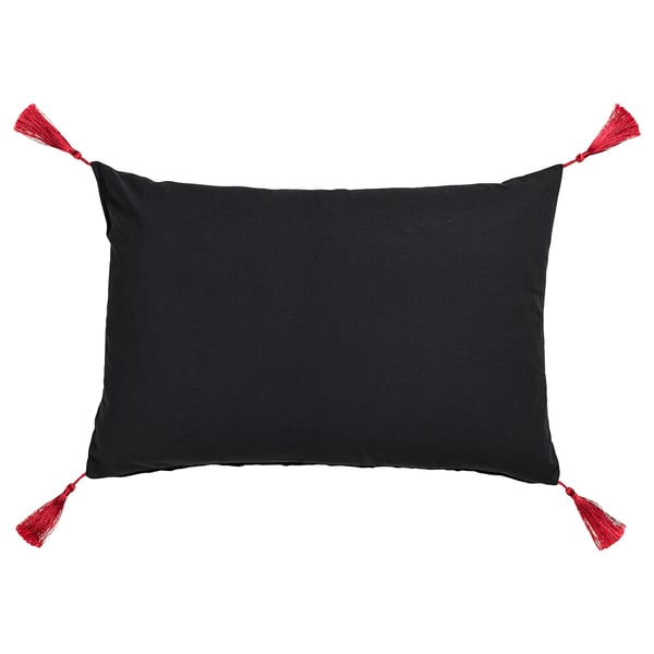 Black rectangular pillow with red tassels, embroidered design.